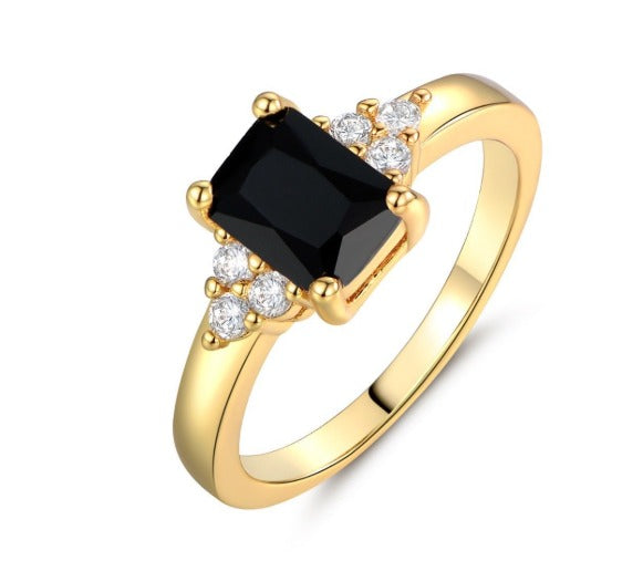 Gylden ring med sort spinel og baguette-snit
